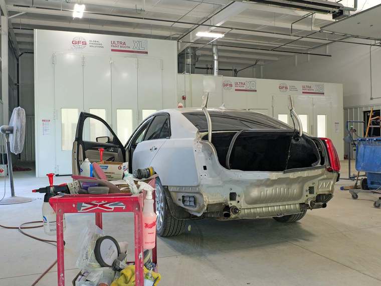 Rear quarter panel in primer during body repair at Jim Winter Collision in Jackson, Michigan